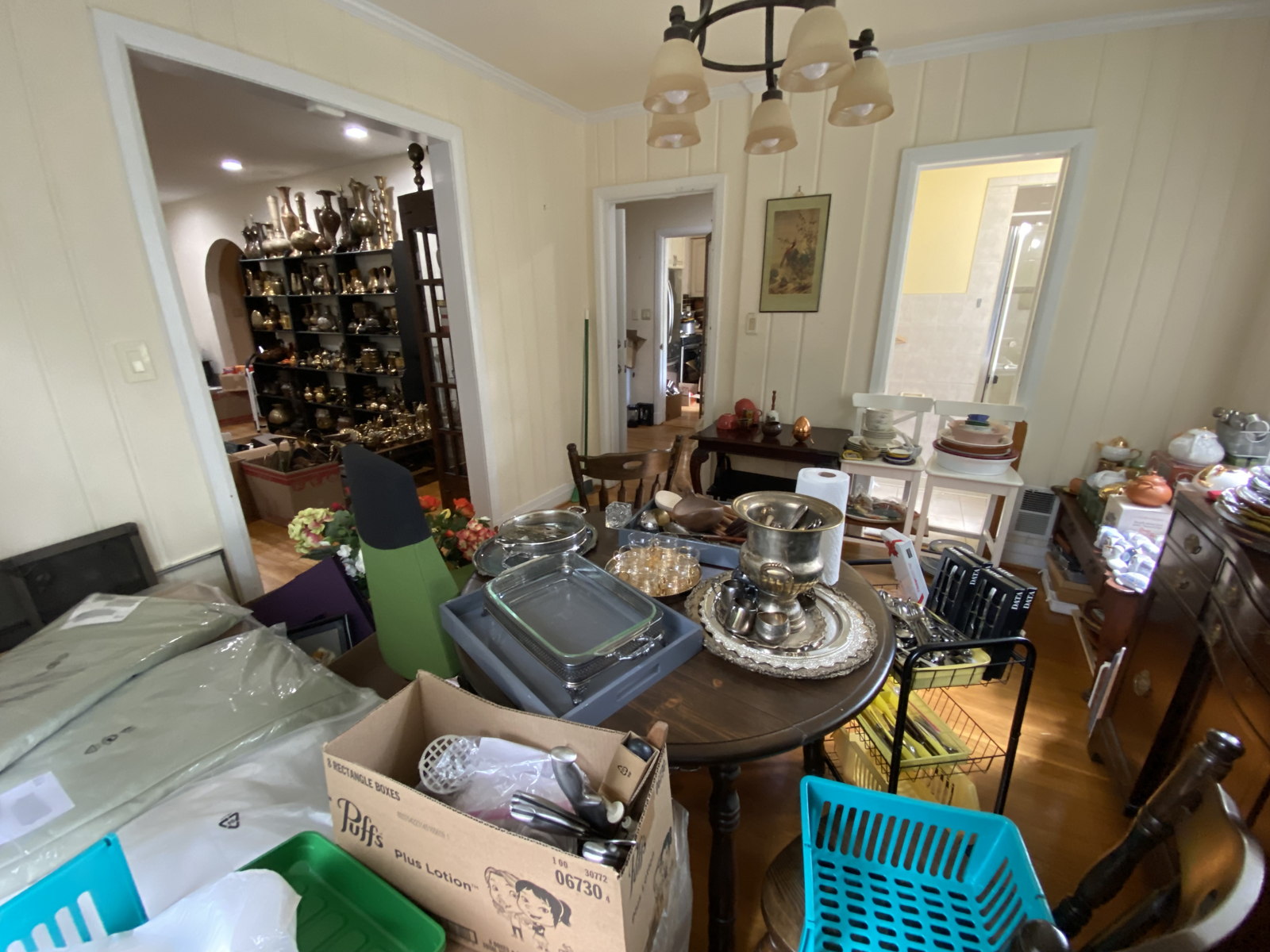 Cluttered Dining Room with Silver, Kitchenware, and Collectibles